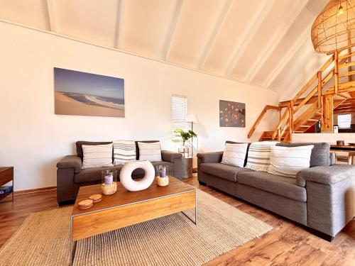 a living room with a couch and a table at Brückendorf 11 Self-catering townhouse in Swakopmund