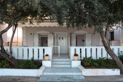 a house with stairs and a white fence at Nerea Eleon Residences in Eleonas