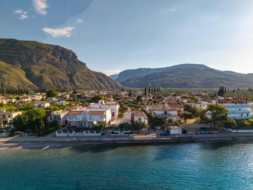 a town on the shore of a body of water at Nerea Eleon Residences in Eleonas
