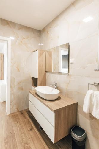 a white bathroom with a sink and a mirror at Villa Aura Vir in Vir