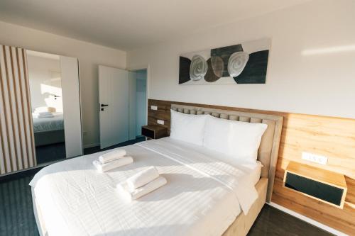 a bedroom with a bed with two towels on it at Villa Aura Vir in Vir