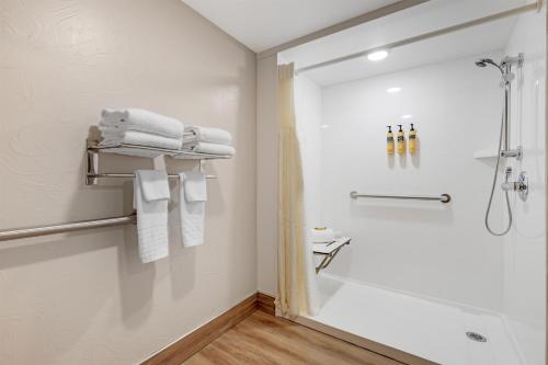 a white bathroom with a shower and a sink at Best Western Plus GranTree Inn in Bozeman