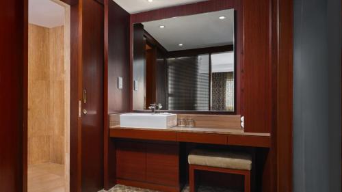 a bathroom with a sink and a mirror at Holiday Inn Singapore Atrium by IHG in Singapore