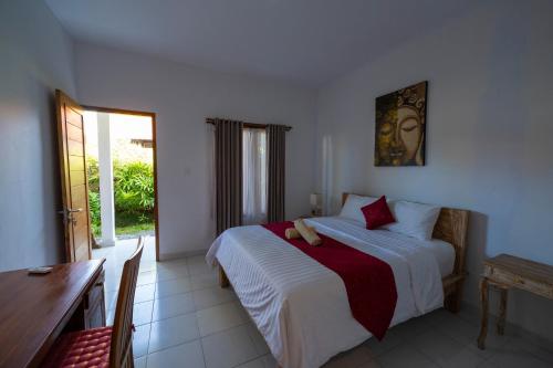 a bedroom with a bed with a teddy bear on it at Villa Raksa Canggu in Canggu