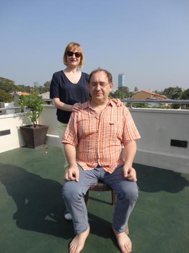 a man sitting on a chair on a roof at Occazia Residence in Colombo