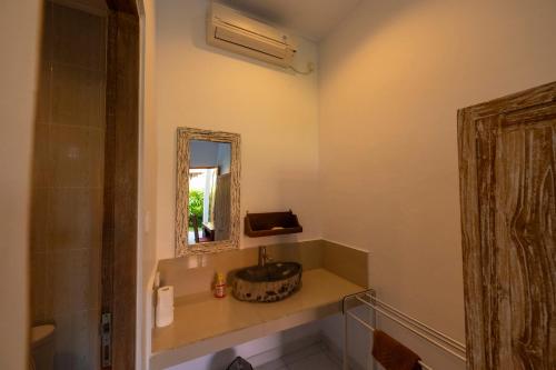 a bathroom with a sink and a mirror at Villa Raksa Canggu in Canggu