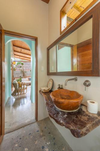 a bathroom with a wooden sink and a mirror at Camanolo Residence in General Luna