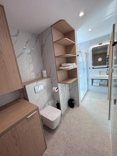 a small bathroom with a toilet and a sink at Marina Sława in Sława