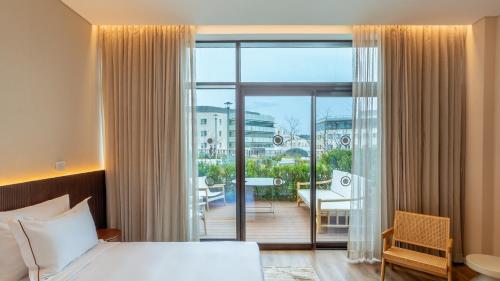 a hotel room with a bed and a balcony at Jacob Modiin in Modi'in-Maccabim-Re'ut