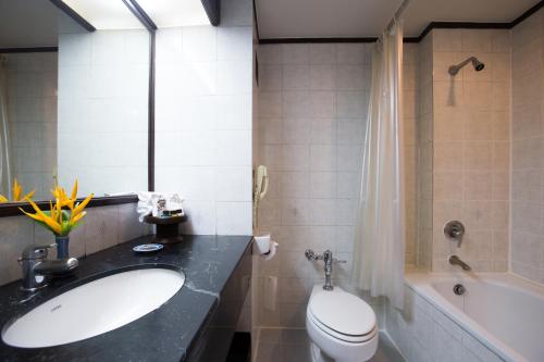 a bathroom with a sink and a toilet and a tub at The Imperial Hotel & Convention Centre Phitsanulok in Phitsanulok