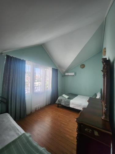 a bedroom with two beds and a dresser and a window at Apartment Ureki in Ureki