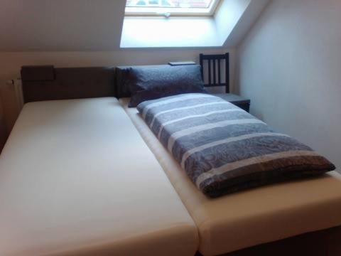1 dormitorio con 2 camas y ventana en Fino da Mario, en Ebersbach an der Fils