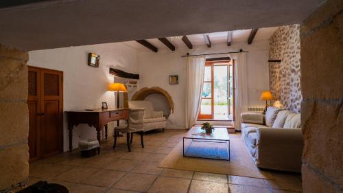 a living room with a couch and a table at Agroturisme Son Cardaix in Artá