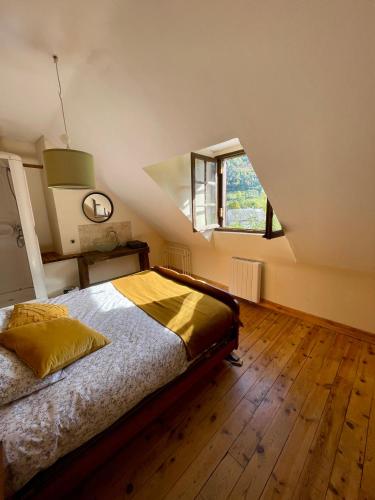 a bedroom with a bed and a large window at Altitude 875 in Arrens-Marsous