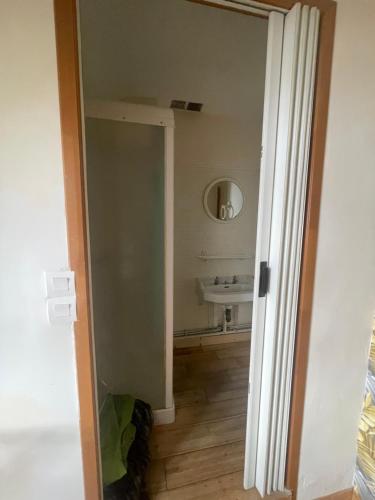an open door to a bathroom with a sink at Altitude 875 in Arrens-Marsous
