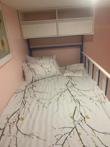 a bed in a small room with a tree blanket at Kenjie Apartment in Cordova
