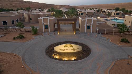 an aerial view of a resort with a fire pit at Arabian Nights Resort & Spa in Shāhiq