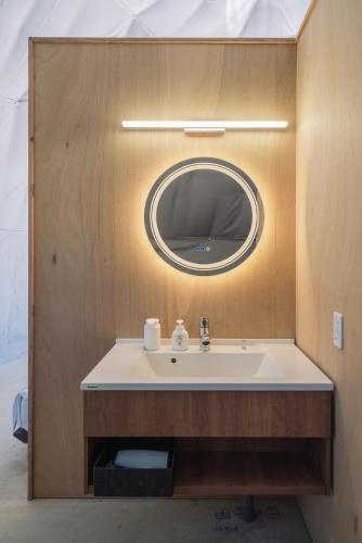 a bathroom with a sink and a mirror at glampark Sesoko -Ocean Terrace- in Sesoko