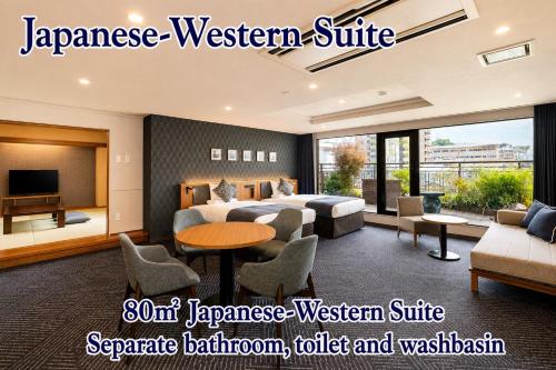 a hotel room with two beds and a table at ART HOTEL Sasebo Central in Sasebo