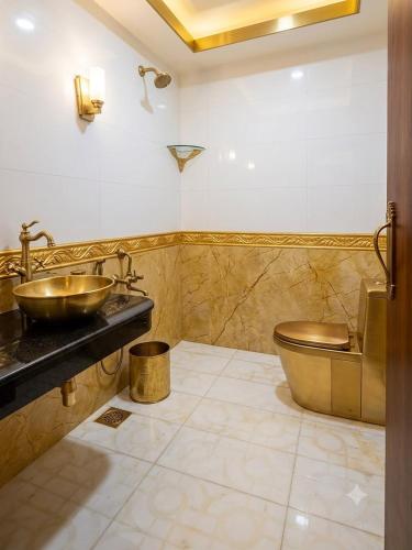 a bathroom with a sink and a toilet at Waves P'opin Resort in Mahabalipuram