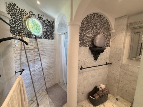 a shower with a glass door in a bathroom at La Villa Fafouille in Cavalaire-sur-Mer