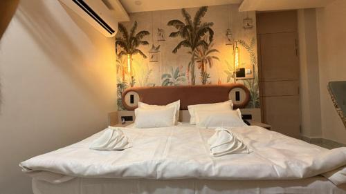 a large white bed with white pillows on it at Shridhar inn in Alīganj