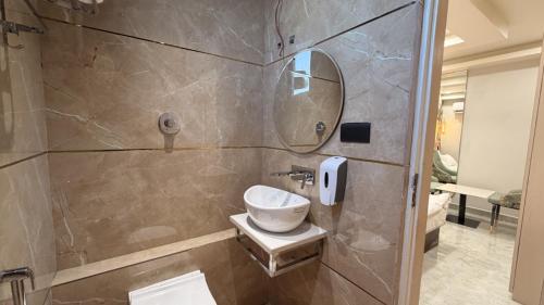 a bathroom with a sink and a mirror at Shridhar inn in Alīganj