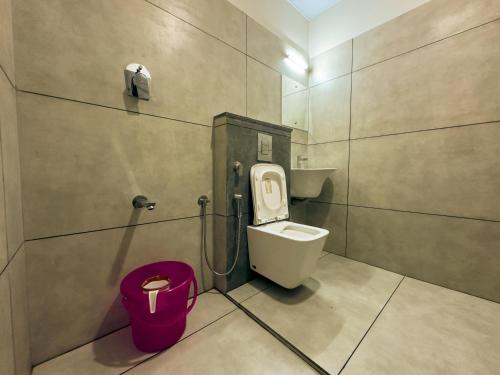 a bathroom with a toilet and a sink at La Dimora luxury pool villa in Vythiri