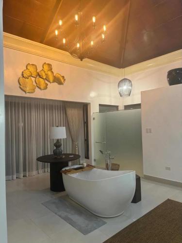 a bathroom with a large white tub in a room at The Villa at Mertolas in Alitagtag