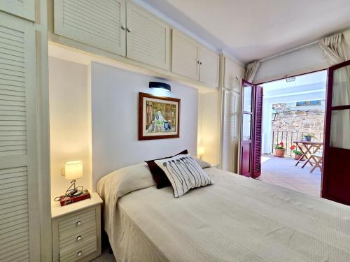 a bedroom with a bed and a door to a patio at EVH137 Can Biel in Tossa de Mar