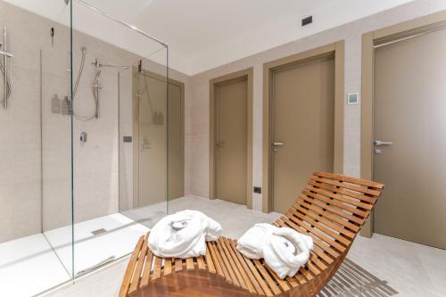 a bathroom with a chair with towels on it at Acca Sporting Milano - AA Hotels in Opera