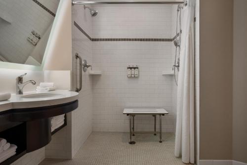 a bathroom with a sink and a shower at Holiday Inn Hotel & Suites St.Catharines-Niagara by IHG in St. Catharines