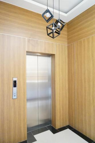 a elevator in a lobby with a glass door at Mulin B&B in Hengchun