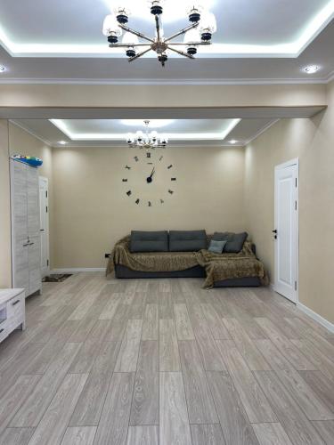 a large bedroom with a large clock on the wall at Коттедж Атлантис in Balykchy