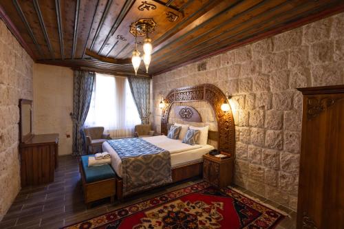 a bedroom with a large bed in a room at Grand Cappadocia Hotel in Göreme