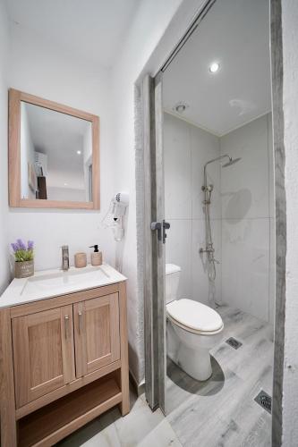 a bathroom with a toilet and a sink and a shower at Almond Beachfront Resort - kalyves Halkidiki in Kalives Poligirou