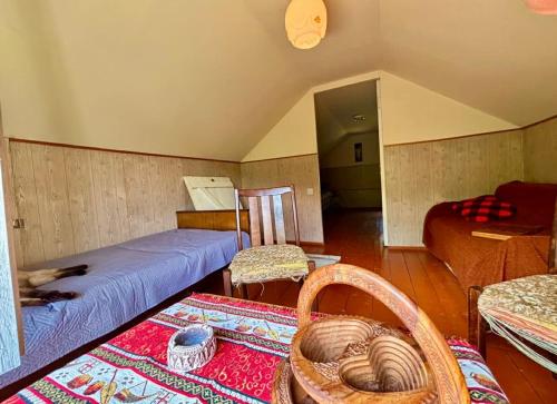 a room with a bed and a couch and a table at Villa Bubi in Tbisi