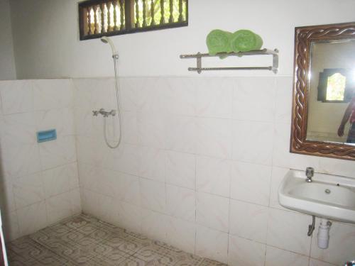 a bathroom with a sink and a mirror at Galang Kangin Bungalows 2 in Amed