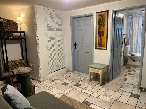 a hallway with a door and a stool in a room at Magnolia Nest in Belgrade