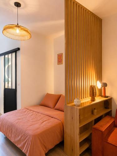 a bedroom with a bed and a wooden wall at Rose Joséphine in Ajaccio