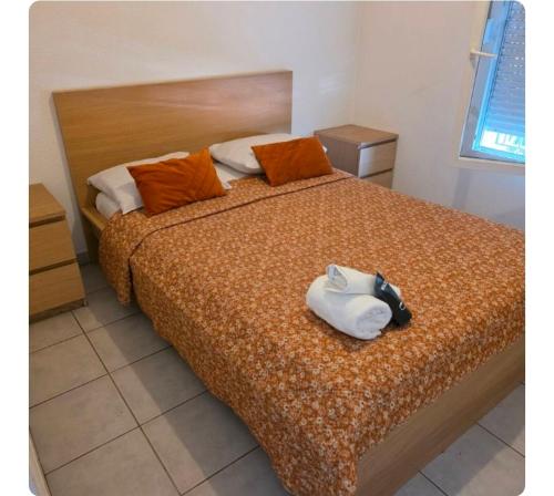 a bedroom with a large bed with a white bag on it at Pierre de lumiere in Toulouse