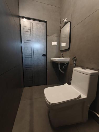 a bathroom with a toilet and a sink at Ayra Inn in Cochin