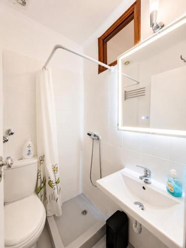 a bathroom with a sink and a toilet and a mirror at Hotel Prinos in Skala Prinou
