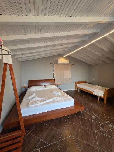 a bedroom with a bunk bed and a ladder at Zoi's sea view in Himare