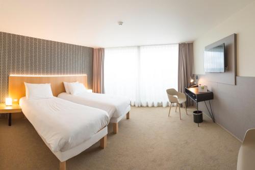 Cama o camas de una habitación en ibis Styles Kortrijk Expo