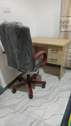 a plastic wrap on a chair in front of a desk at BP Aura Stay in Akitan
