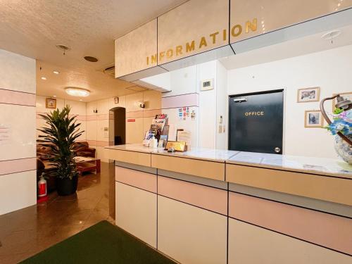 an office lobby with a counter and a sign that reads immigration at Weekly Green In Namba in Osaka