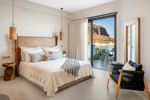 a bedroom with a bed and a view of the water at Gaia-Castle vista in Monemvasia