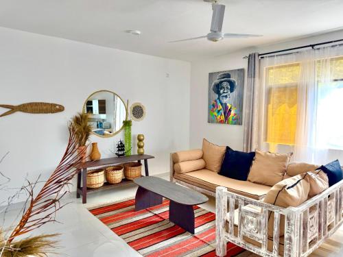 a living room with a couch and a table at KK Homes in Diani Beach