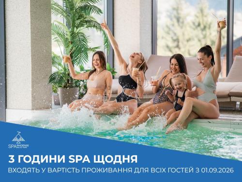 a group of women sitting in the water in a swimming pool at Phoenix Relax Park in Bukovel